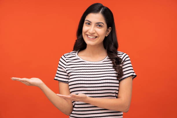 istock young woman on orange background, 1334881861