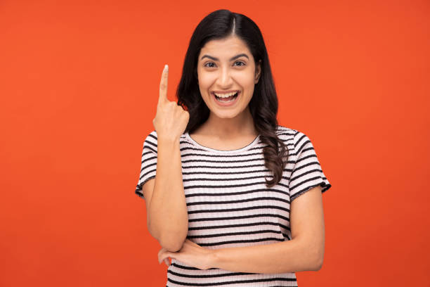 istock young woman on orange background, 1334881898