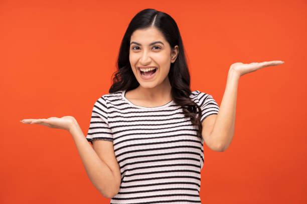 istock young woman on orange background, 1334882420