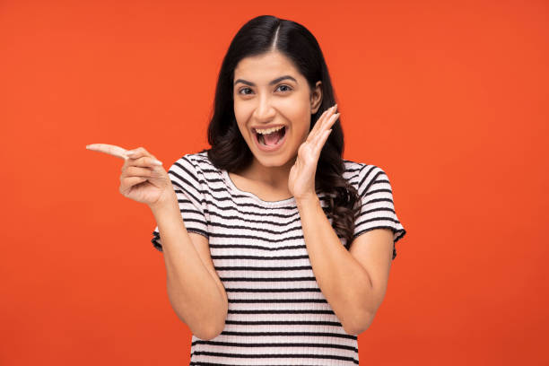 istock young woman on orange background, 1334882459
