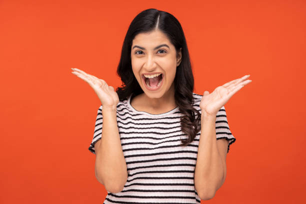 istock young woman on orange background, 1334882481