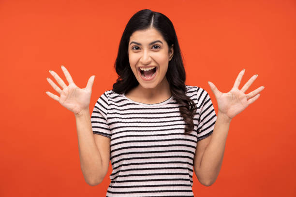 istock young woman on orange background, 1334882556
