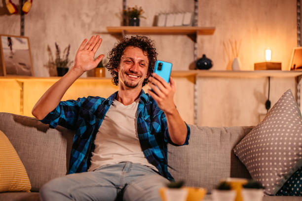 istock Man having video call with his friend using smart phone 1334882612