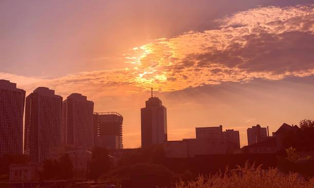 istock Urban sunset over city. Dramatic sky clouds. Impressive cloudscape in heaven. 1334883713