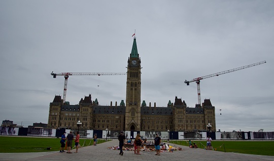 Parliament Hill main building under construction with two cranes and memorial to Every Child Maters