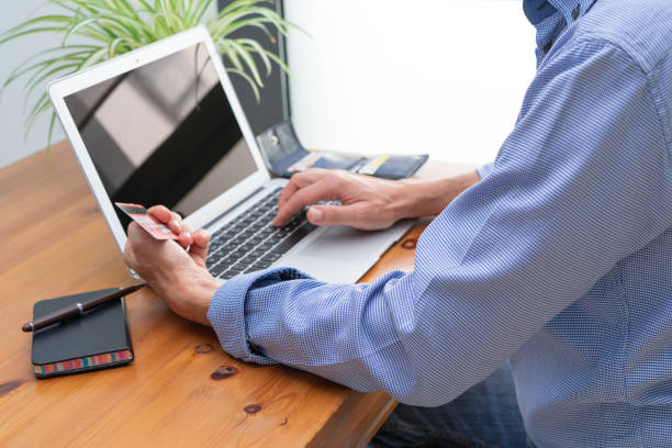 istock Man making online payments in front of the computer. 1334884395
