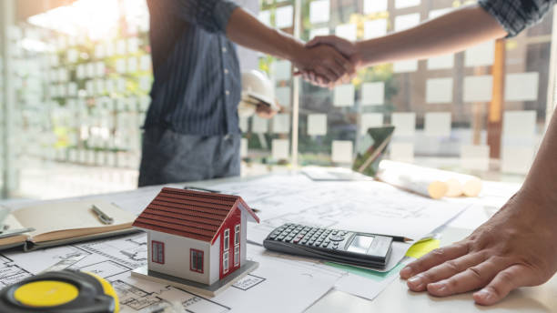 istock Handshaking between an architect and a contractor of agreement after collaboration. 1334886381