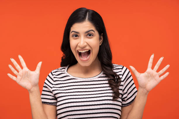istock young woman on orange background, 1334886579