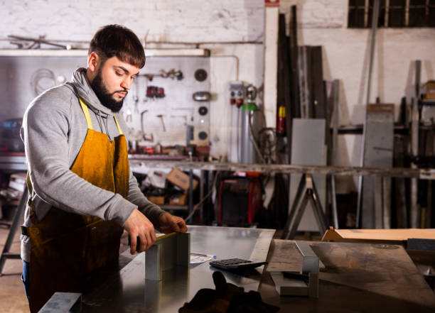 istock Foreman measures part and takes notes on paper 1334887458
