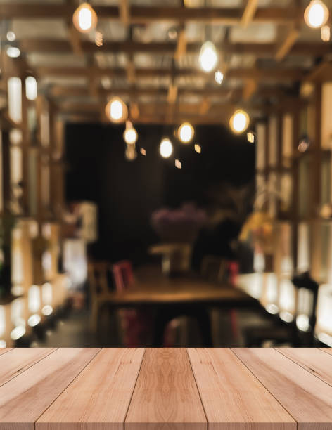 istock Empty wooden table top with lights bokeh on blur restaurant background 1334887840