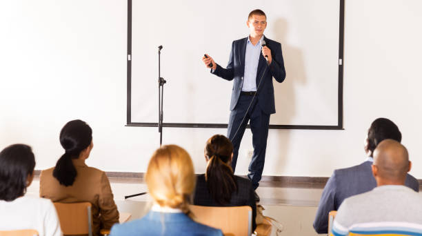 istock Male coach giving speech at conference hall 1334888635