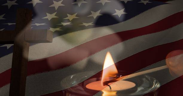 istock Composition of crucifix and candle over american flag 1334888997