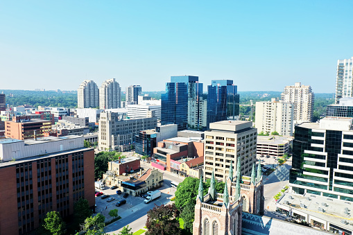 Skyline of Toronto, Ontario, Canada with green park trees in the foreground.