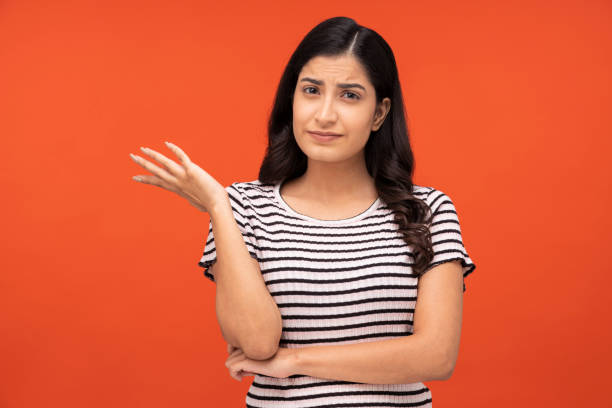 istock young woman on orange background, 1334890445