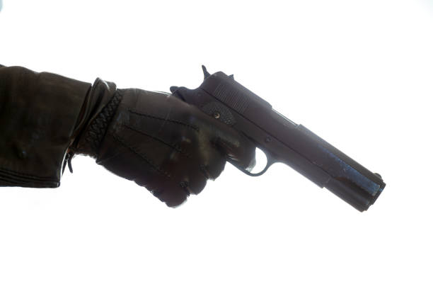 A masked man holding a gun, aiming at something, studio image, white background