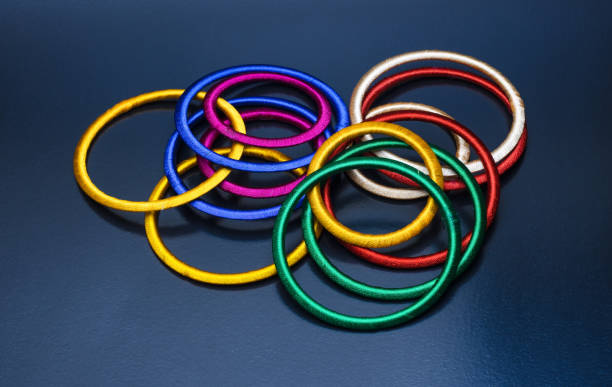 istock A bunch of scattered colorful bangles on dark rough background 1334891606