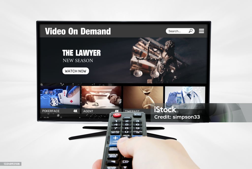 Video on demand, TV streaming, multimedia Video on demand, TV streaming, multimedia. Hand holding remote control Streaming Service Stock Photo
