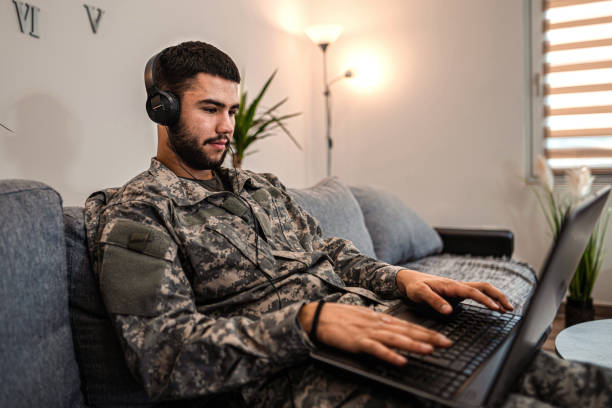 istock Soldier is sitting on the couch in his house 1334894743