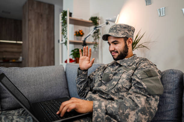istock Soldier is sitting on the couch in his house 1334894745