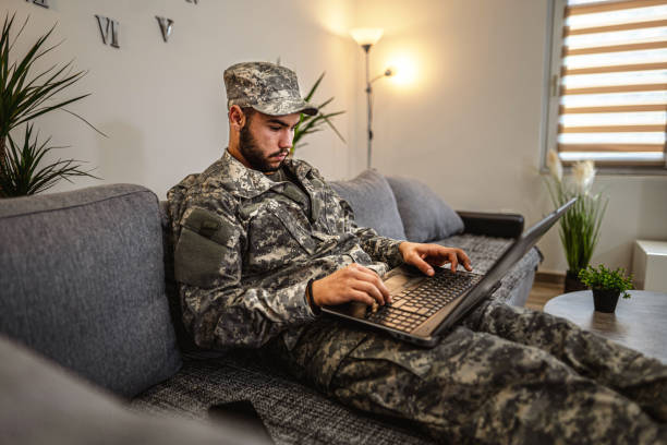 istock Soldier is sitting on the couch in his house 1334894762
