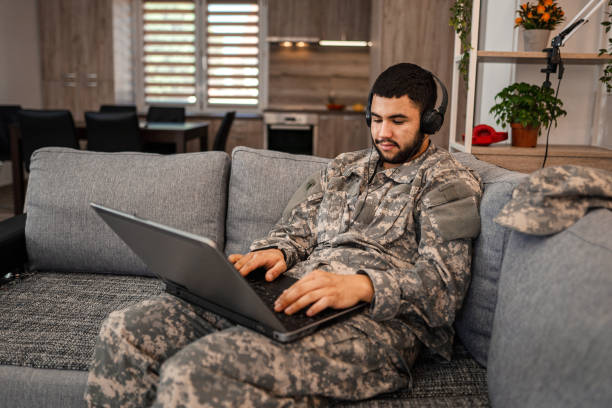 istock Soldier is sitting on the couch in his house 1334894763