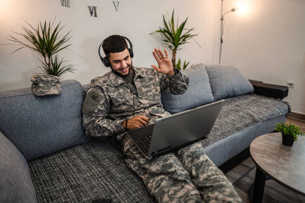 istock Soldier is sitting on the couch in his house 1334894793