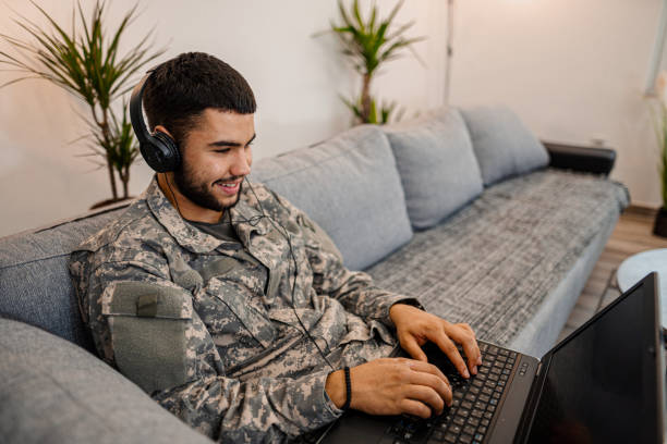 istock Soldier is sitting on the couch in his house 1334894872