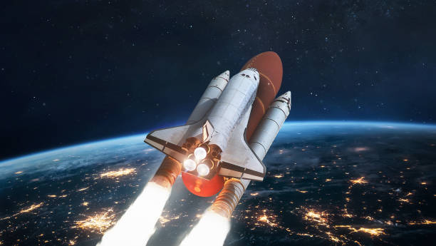 istock Space shuttle in space near Earth planet at night. Spaceship on orbit. View from international space station. Expedition on ISS. Elements of this image furnished by NASA 1334900055