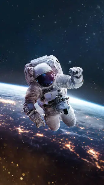 Astronaut fly in outer space on orbit of Earth planet. Night. City lights. Spaceman in spacesuit. Elements of this image furnished by NASA (url: https://images-assets.nasa.gov/image/iss040e090540/iss040e090540~orig.jpg https://images-assets.nasa.gov/image/sts069-714-046/sts069-714-046~medium.jpg)