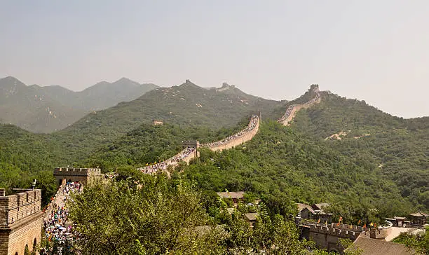 a segment of the great wall of china with tourists in badalin
