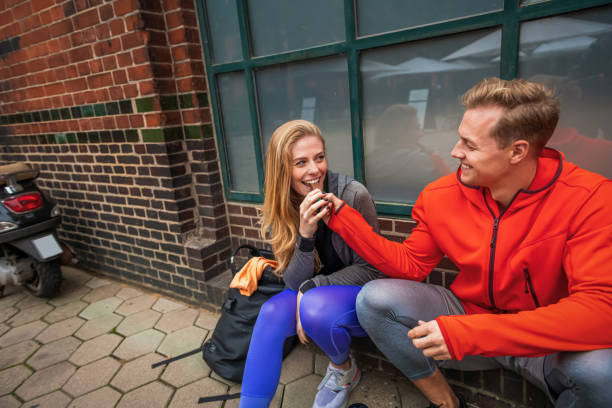 istock Two young people in sportswear having break after jogging 1334901189