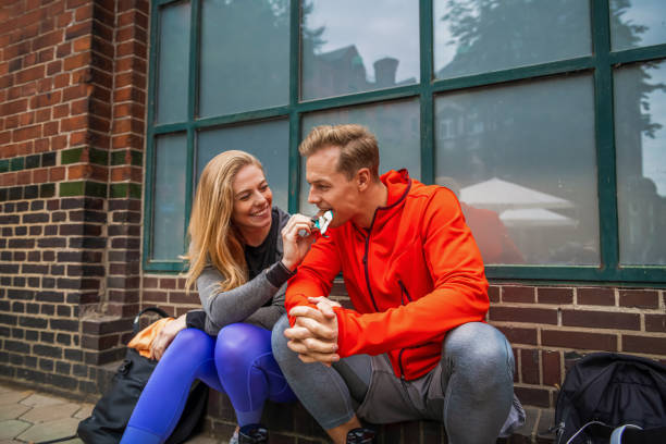 istock Two young people in sportswear having break after jogging 1334901203