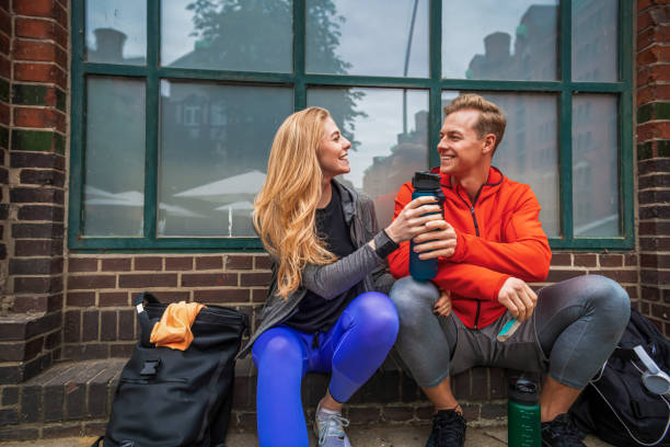 istock Two young people in sportswear having break after jogging 1334901241