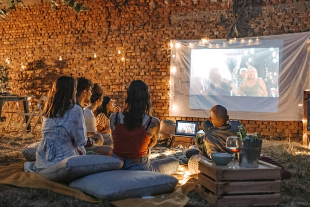 Watching our favourite movie Photo of friends at backyard movie night. image type stock pictures, royalty-free photos & images