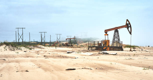 bomba de óleo na costa da areia do mar - oil rig sea oil well oil drill - fotografias e filmes do acervo