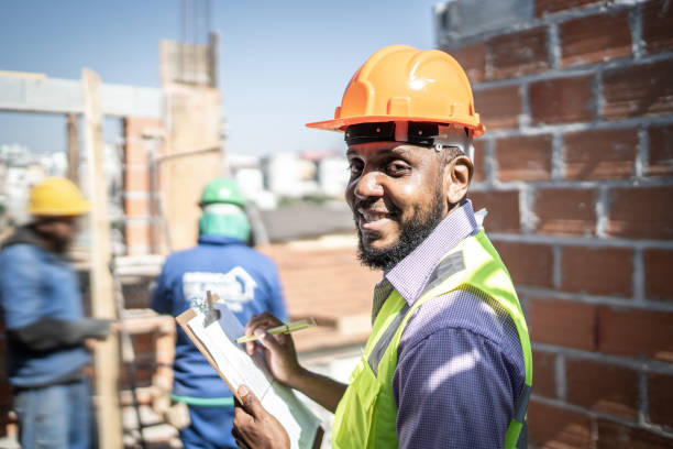 istock Portrait of a construction worker holding a clipboard working at a construction site 1334906963