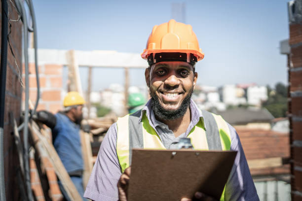 istock Portrait of a construction worker holding a clipboard working at a construction site 1334906965