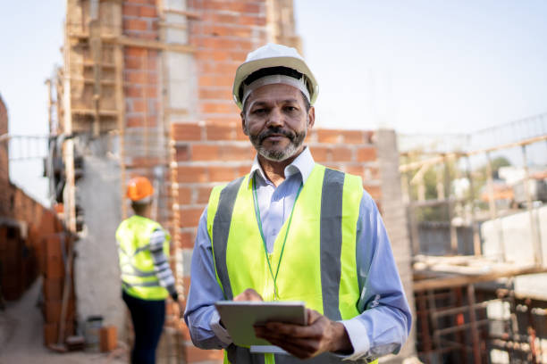 istock Portrait of a construction worker holding a clipboard working at a construction site 1334907136