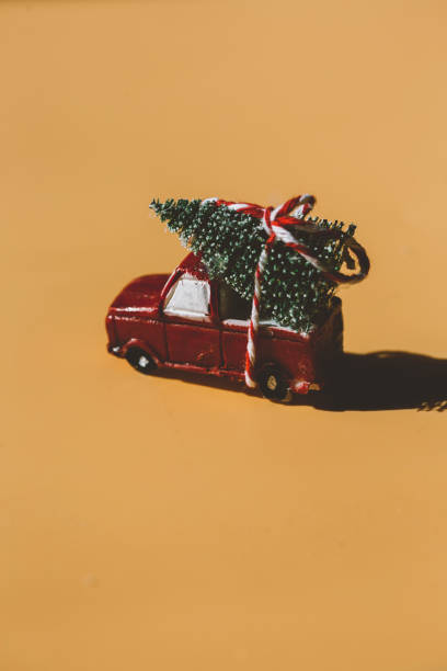 istock a red car delivering a Christmas tree. new year, christmas 1334908426
