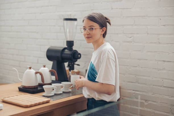 istock Charming young woman working in coffee shop 1334910704