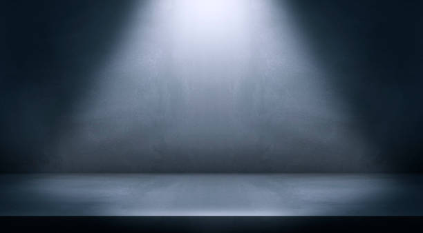 istock Black and blue abstract cement wall and studio room, Spot Lighting, and interior texture for display products. wall background 1334914289