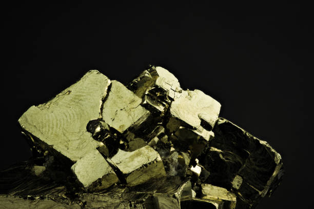 macro photography of natural mineral from geological collection - crystal of iron pyrite (fool's gold, sulfur pyrite) on white background