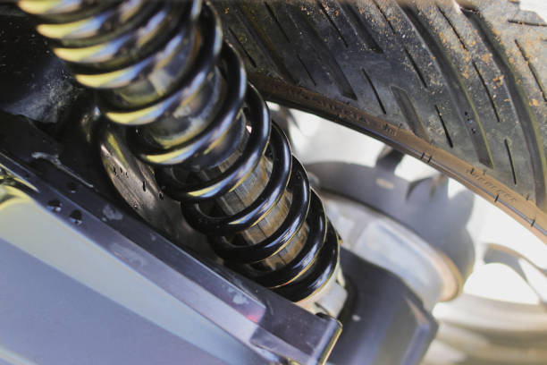 Close-up view of Motorcycle Shock Breaker or Shock absorber on a rear wheel. Motorcycle accessories, Garage, and Services Concept.