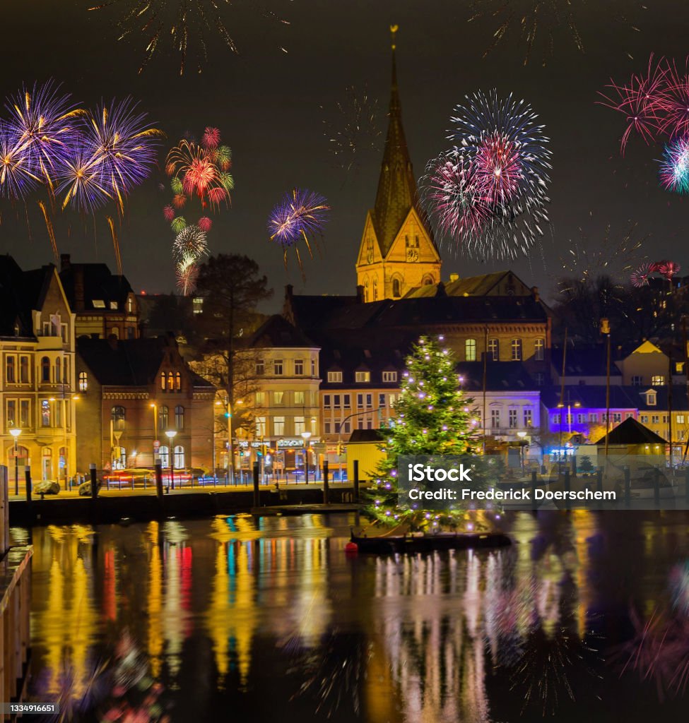 View of Sylvester festive lighting and romantic atmosphere with firework in the Flensburg at night. Maritime New Year's Eve Fireworks Celebration. Firework Display Stock Photo
