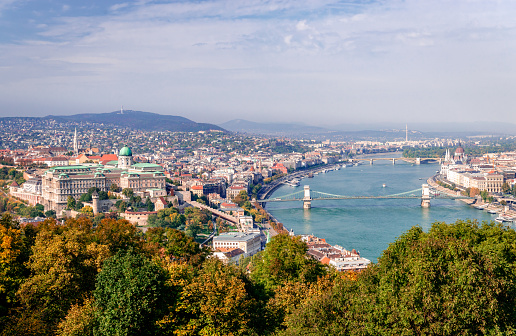 Panoramic view of Budapest and river Danube, in Hungary. The Castle of Buda is on the left and the bridge that spans river Danube is the famous Chain Bridge. Photo taken from Gellért Hill.
