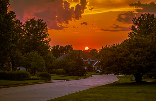 Beautiful view of sunset over Midwestern suburban neighborhood  in summer