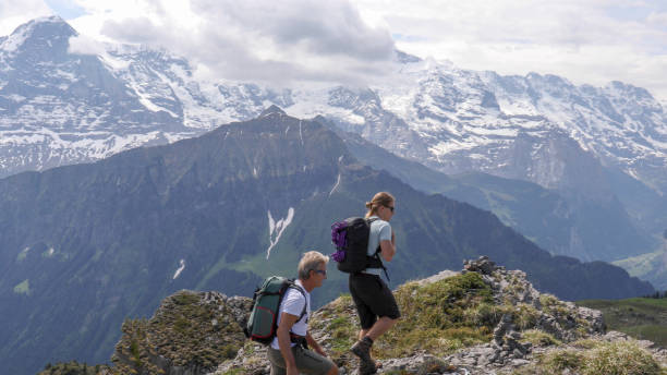 istock Father and son hike along sunny mountain ridge 1334919346