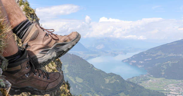istock View of man's hiking boots on sunny mountain ridge 1334919372