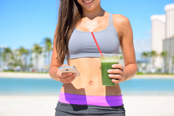 istock Woman drinking vegetable Green detox smoothie 1334920801