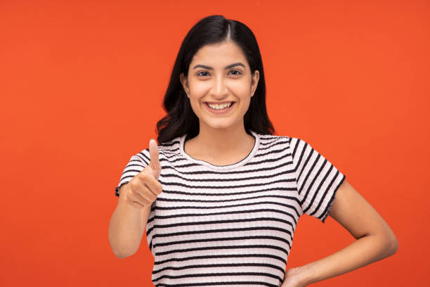 istock young woman on orange background, 1334920872